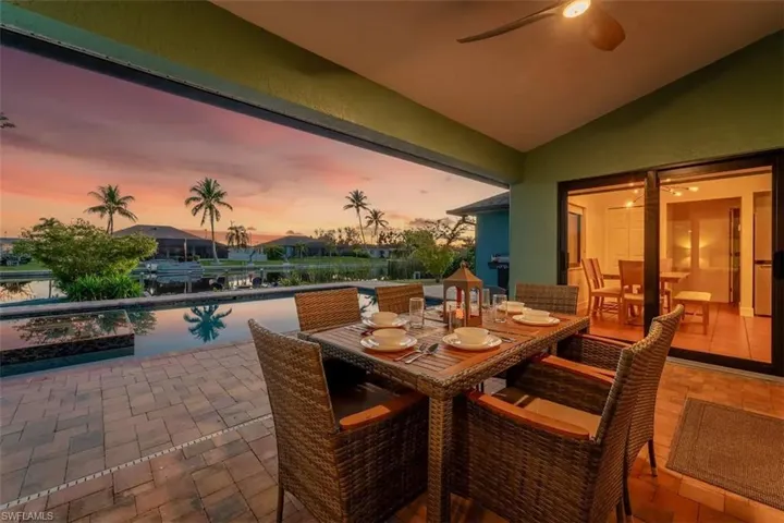 Living area with tile patterned flooring, lofted ceiling, ceiling fan, recessed lighting, and french doors