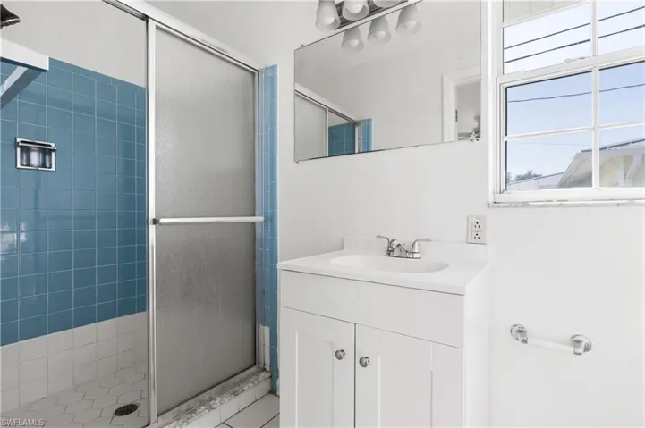 Bathroom featuring walk in shower and vanity