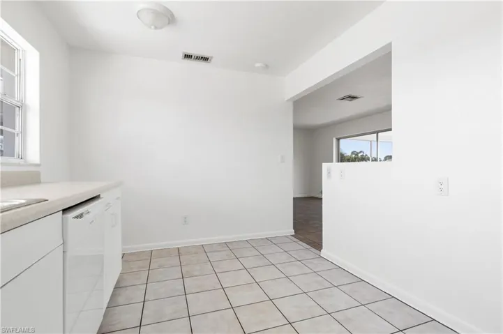 Kitchen with dishwasher and light tile patterned floors