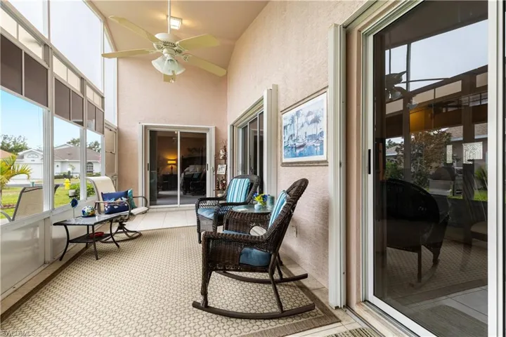 Sunroom with ceiling fan and vaulted ceiling