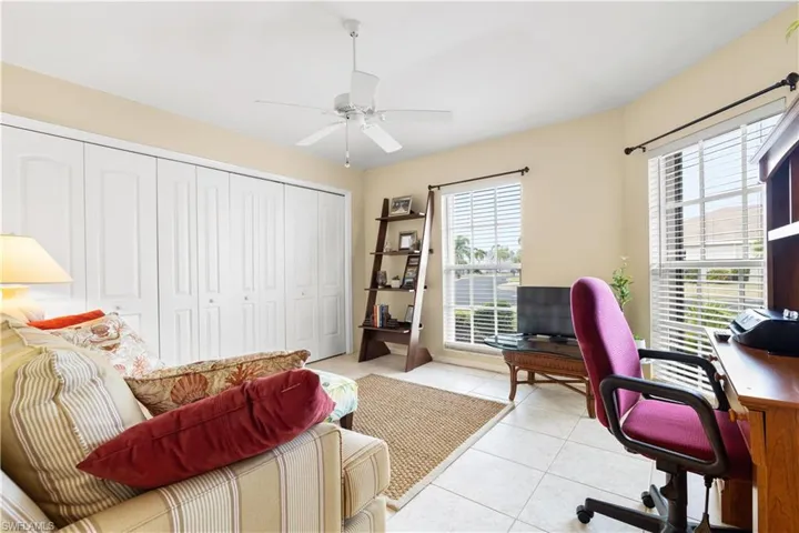 Office area featuring ceiling fan and light tile patterned flooring