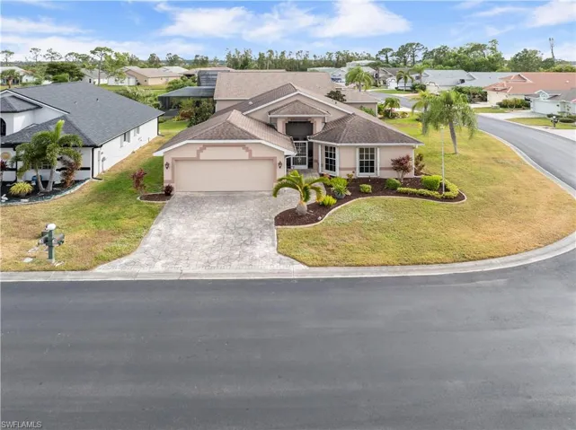 View of front of home featuring a front yard and a garage