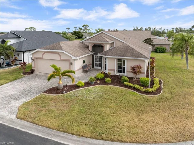 Single story home featuring a front yard and a garage