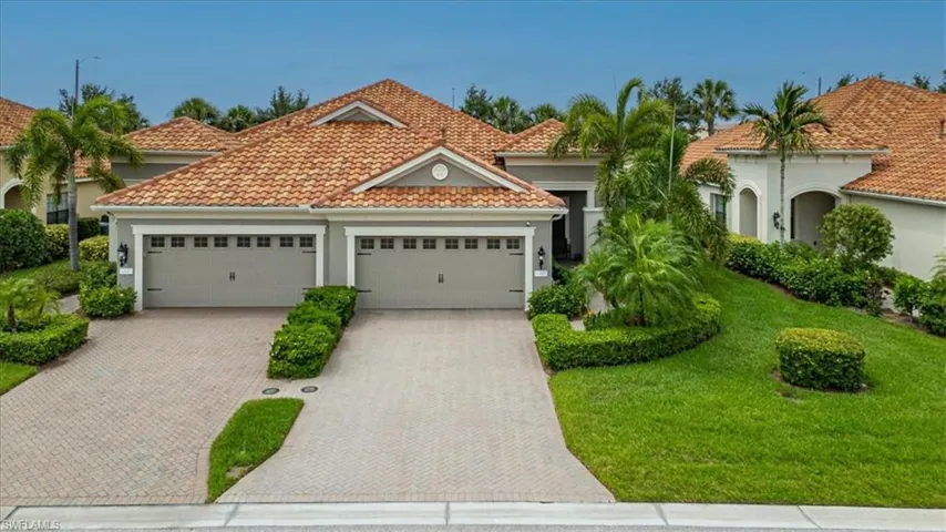 Mediterranean / spanish-style home featuring a garage and a front yard