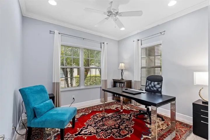 Home office with crown molding and ceiling fan