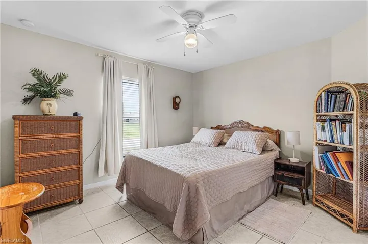 Bedroom featuring light tile patterned floors and ceiling fan