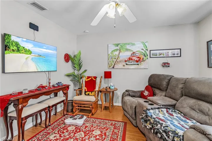 Living room featuring wood finished floors and ceiling fan