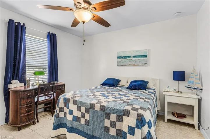 Tiled bedroom with ceiling fan