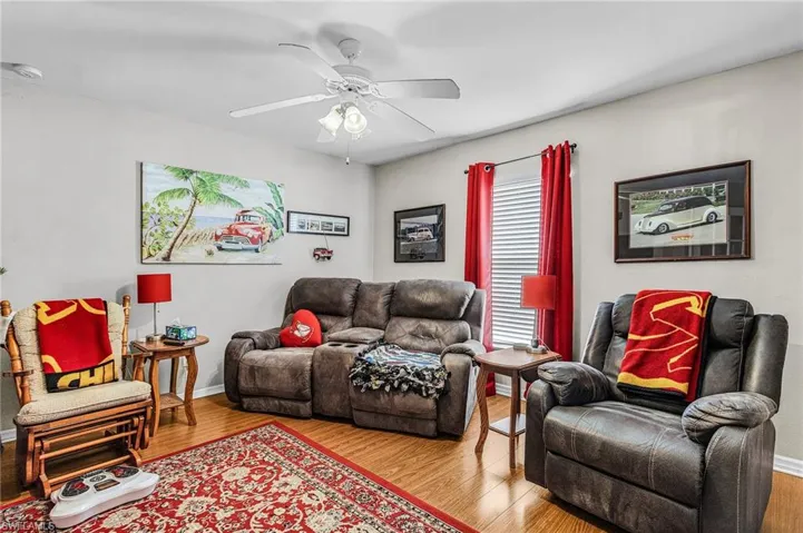 Living area with wood finished floors and a ceiling fan