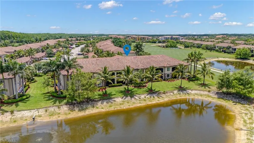 Aerial view of residential area featuring a large body of water