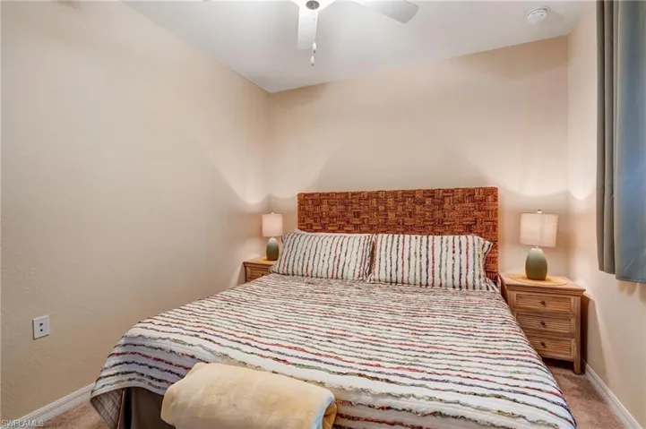 Carpeted bedroom featuring baseboards and a ceiling fan