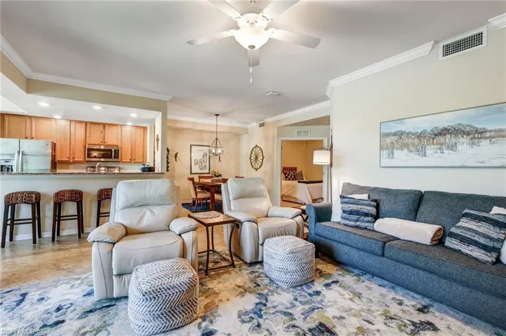 Living area featuring ornamental molding and ceiling fan