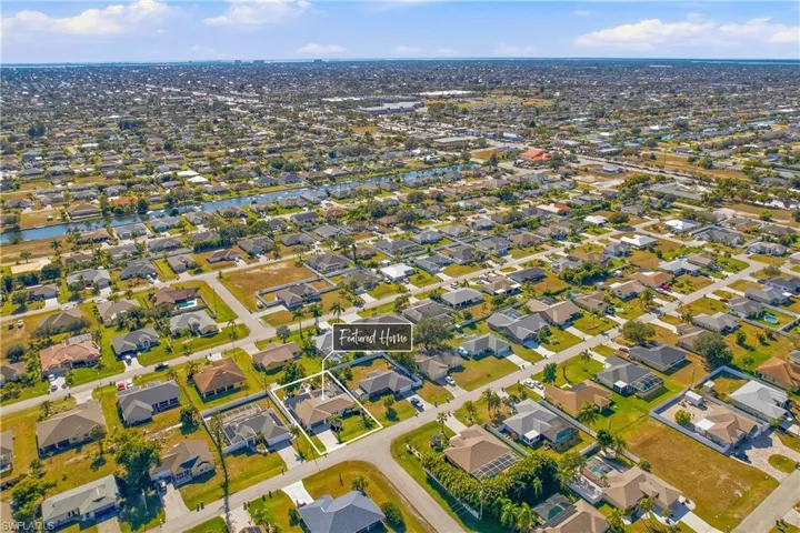 Aerial view of property's location with nearby suburban area