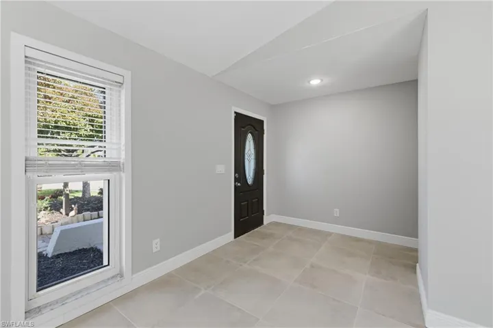 Entrance foyer with lofted ceiling and recessed lighting