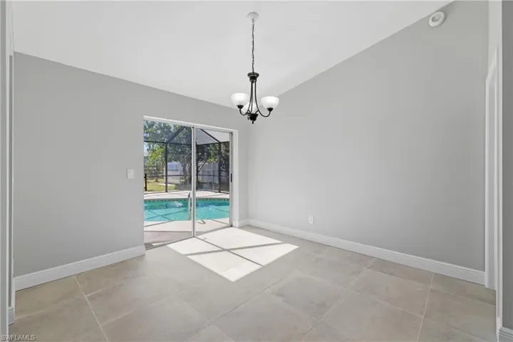 Empty room featuring lofted ceiling and a sunroom