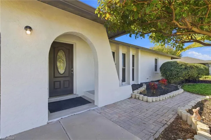 View of exterior entry featuring stucco siding