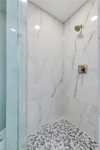 Bathroom with a marble finish shower