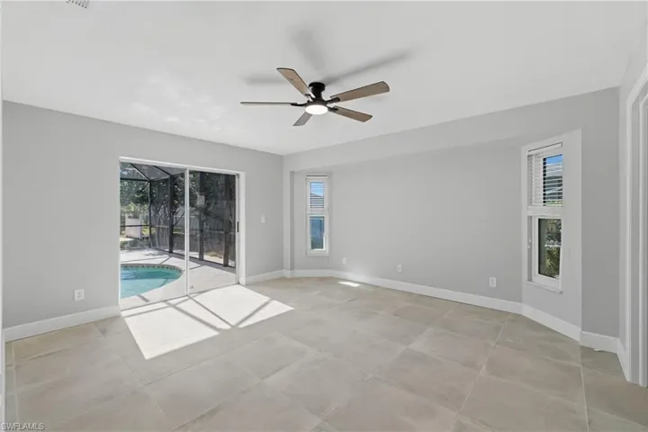 Spare room with a sunroom and ceiling fan