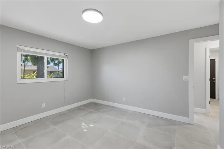 Unfurnished room featuring baseboards