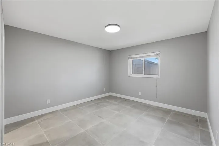 Empty room featuring baseboards