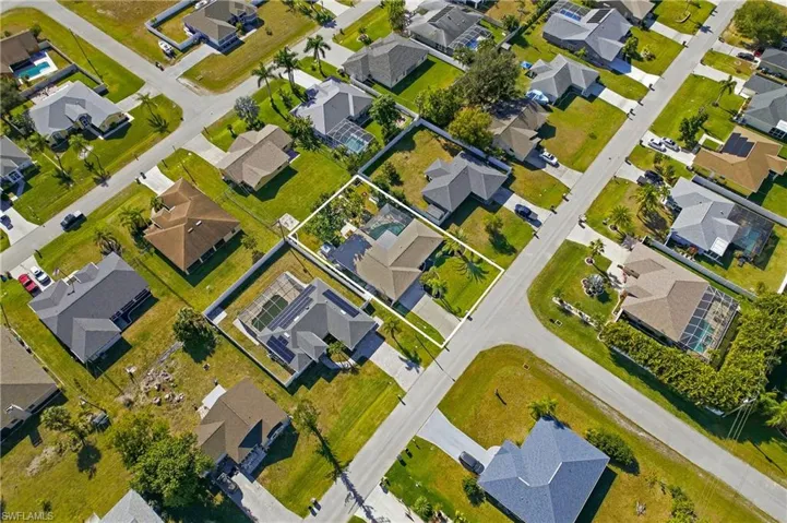 Aerial view of property's location with nearby suburban area