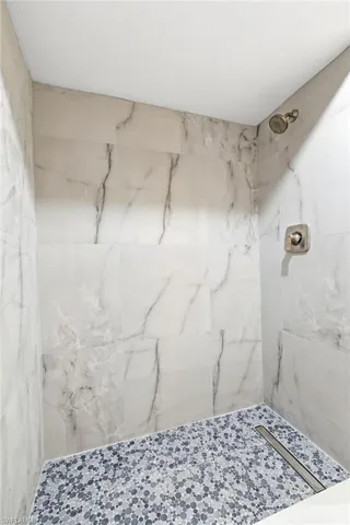 Bathroom with a marble finish shower