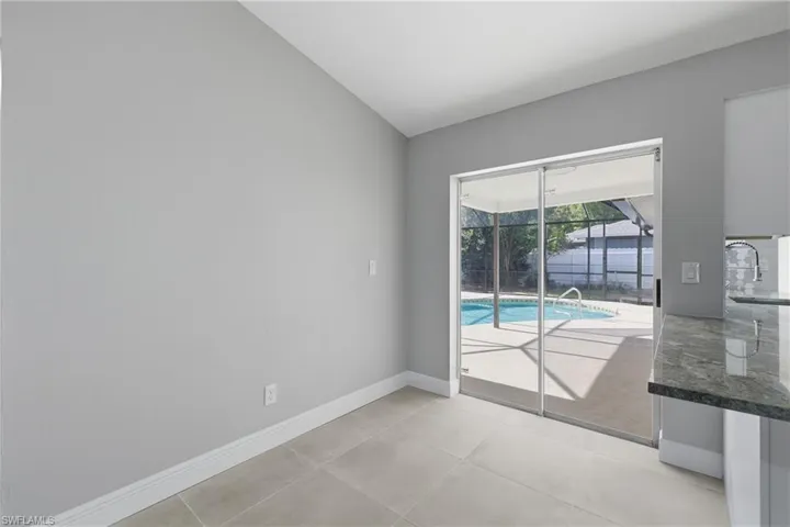Unfurnished room with a sunroom and lofted ceiling