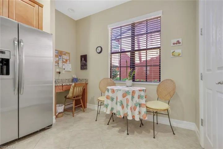 Dining space with an office area and light tile patterned flooring