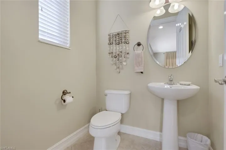 Half bathroom featuring baseboards and tile patterned flooring