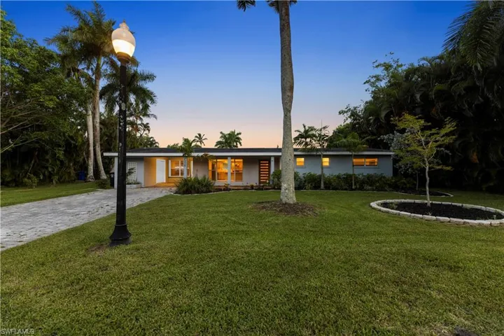 Ranch-style home featuring a yard