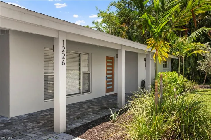 Doorway to property with a patio area