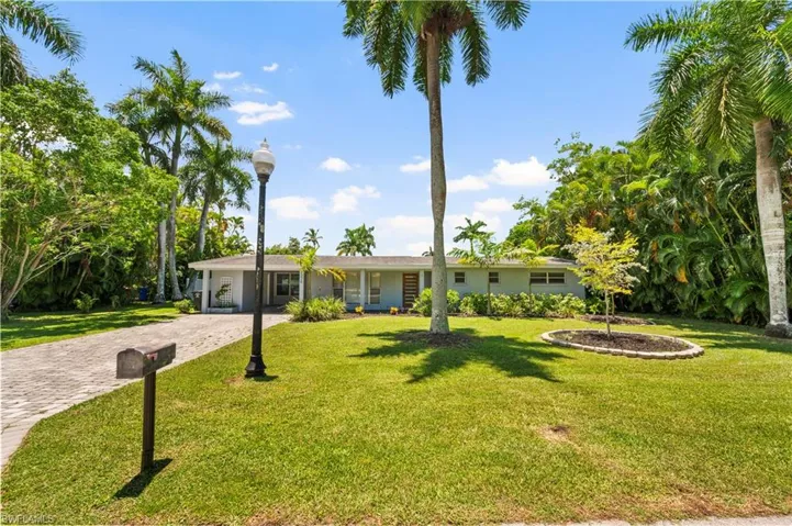 Ranch-style home with a front lawn