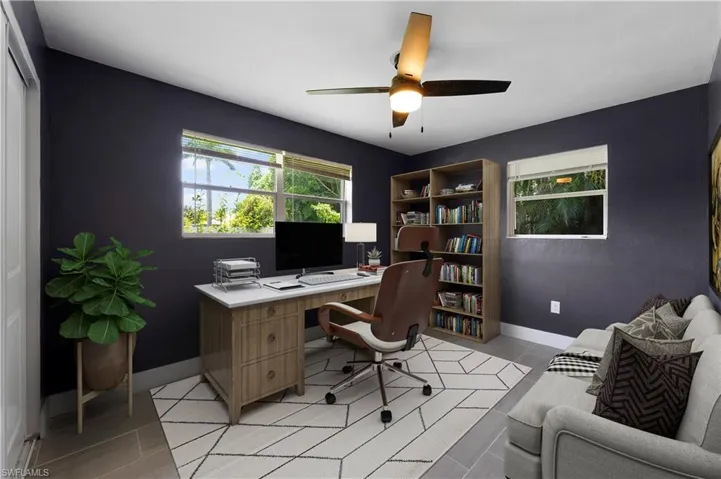 Office space featuring light tile patterned flooring and ceiling fan