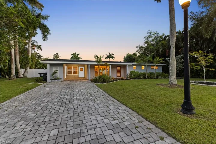 Single story home featuring a yard