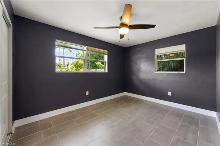 Tiled empty room with ceiling fan