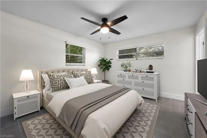 Bedroom featuring ceiling fan and dark tile patterned floors