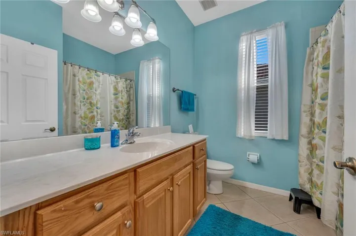 Full bathroom with vanity, a tub/shower combo, and light tile patterned floors