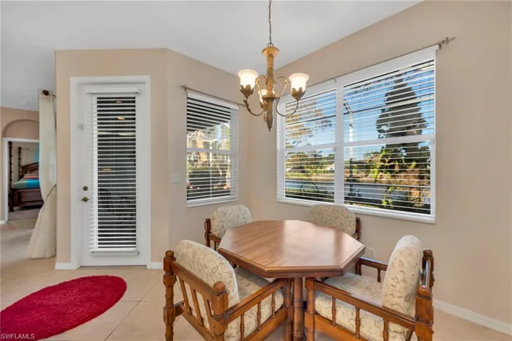 Breakfast area with door to Lanai, a chandelier and light tile patterned floors