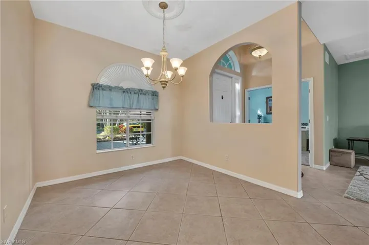 Dining room featuring a chandelier and light tile patterned floors