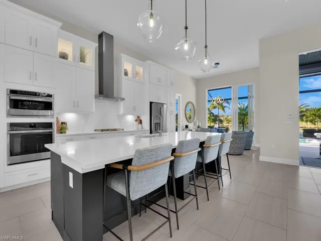 Designer Cabinetry, Quartz counters & backsplash, walk-in pantry, pull-out drawers, soft closing drawers & cabinets, & pendant lighting.