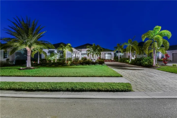 New Foxtail palm trees, Clusia privacy hedges, and pristine landscaping added in front, side and back of home with landscape lighting