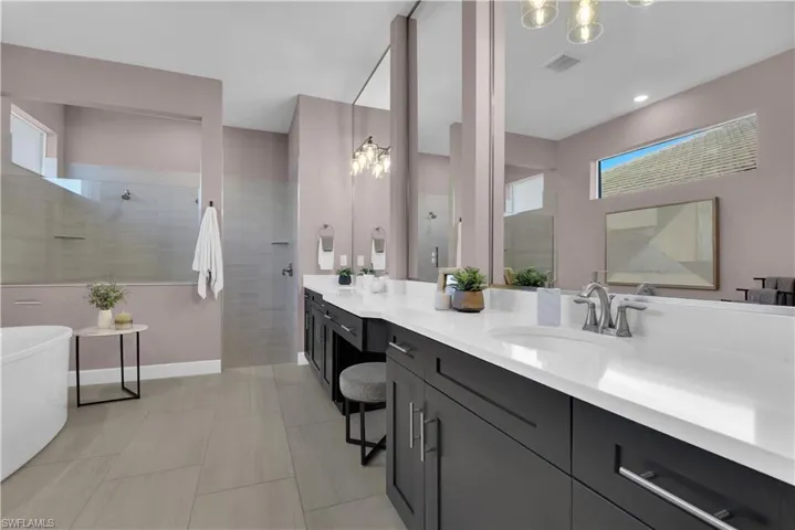 Master Bath - custom mirrors to ceiling, separate garden tub and walk-in tile shower with multiple shower heads, custom mirrors to ceiling,
