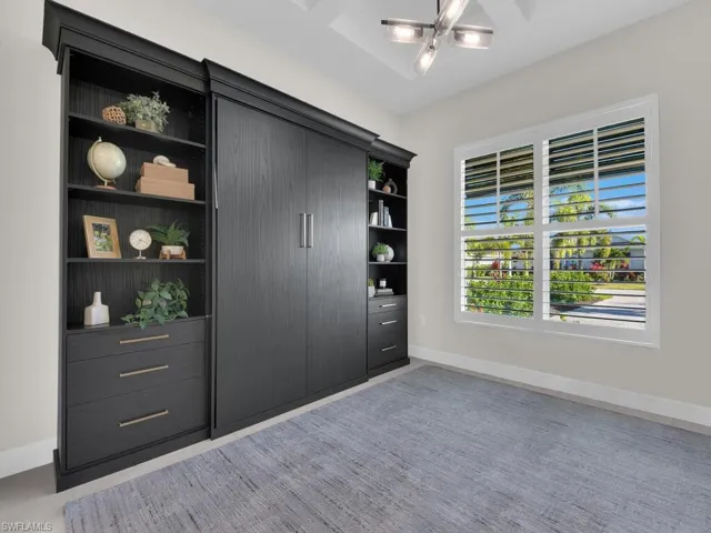 Guest Room/Office - glass doors with pull-down shades, murphy bed & a custom closet.