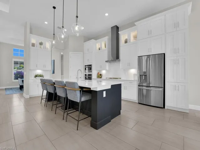 Gourmet kitchen with luxury white cabinetry plus additional lighted upper cabinets & side cabinets added to the right of the refrigerator, under & above cabinet lighting