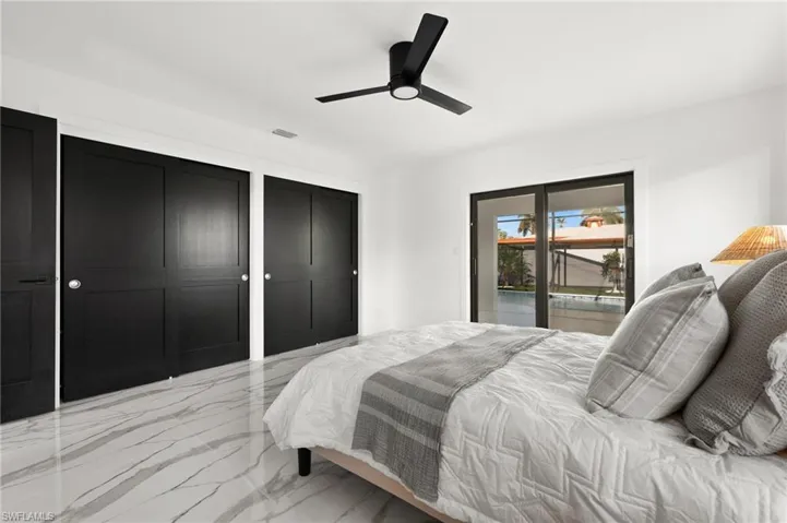 Bedroom featuring ceiling fan, access to outside.