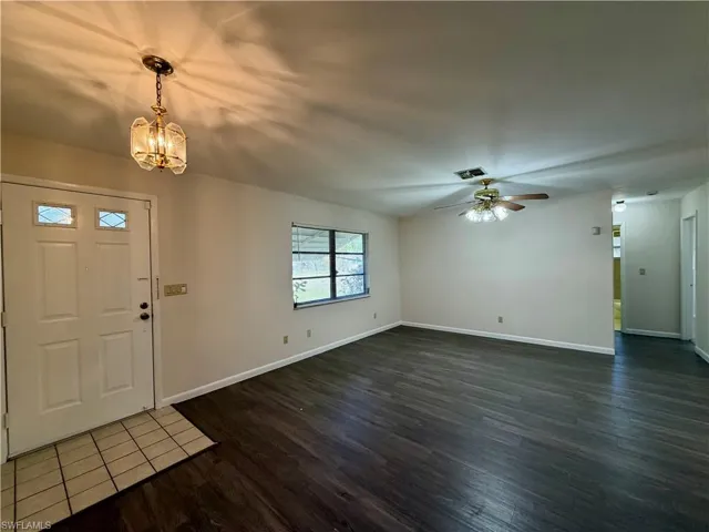 Entryway with wood-finish flooring and a tiled landing