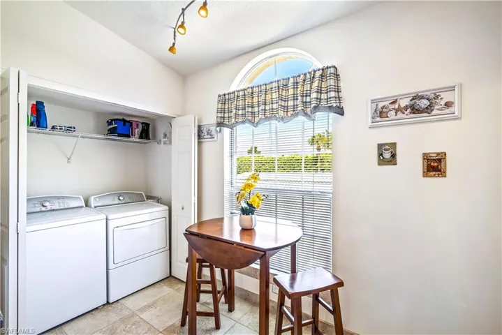 Laundry room with a textured ceiling and independent washer and dryer