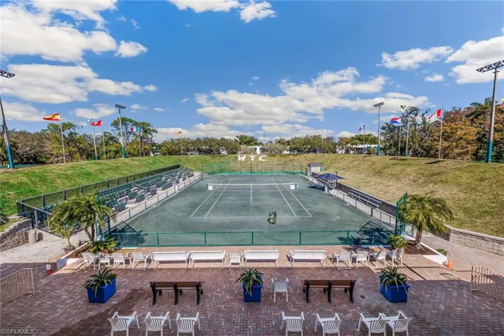 View of swimming pool with tennis court