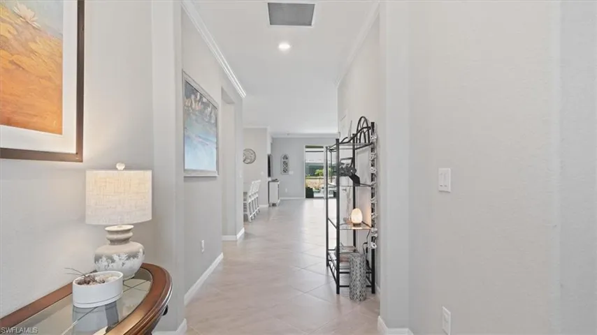 Hall featuring ornamental molding, light tile patterned floors, and recessed lighting