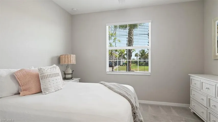 Bedroom featuring baseboards and light colored carpet